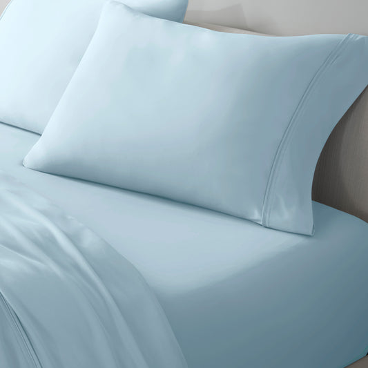 Light blue pillowcase and sheets on a bed.