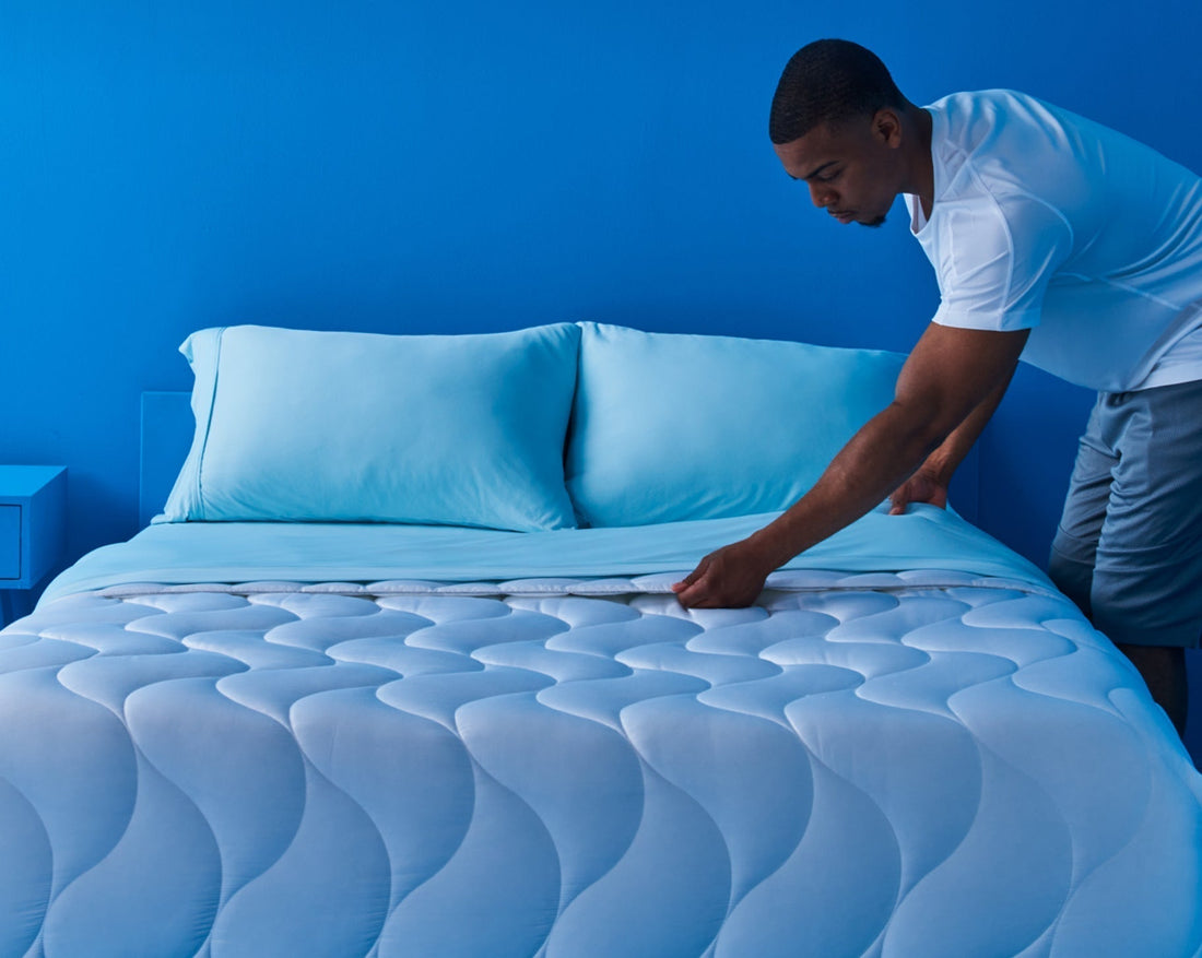 a man making a bed. 