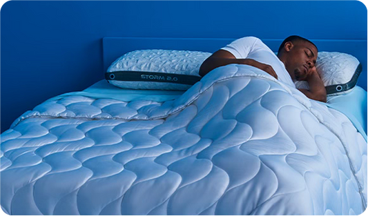 A man sleeping on comfortable bedding. 
