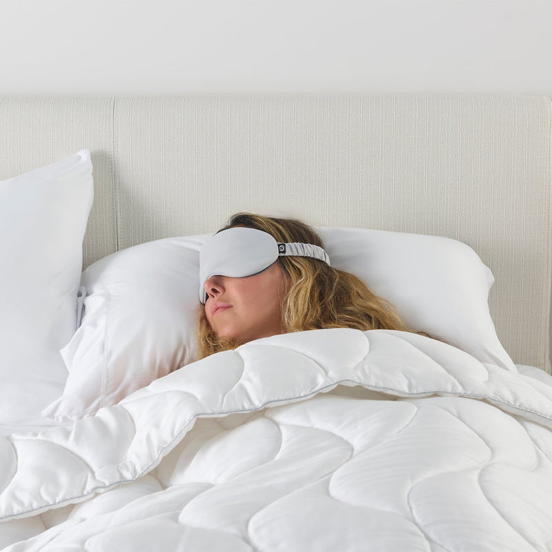A woman sleeping with a sleep mask. 