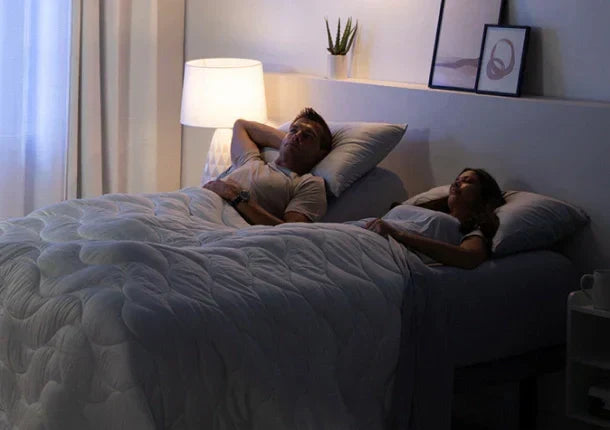 A couple relaxing in bed.