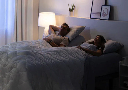 A couple relaxing in bed.