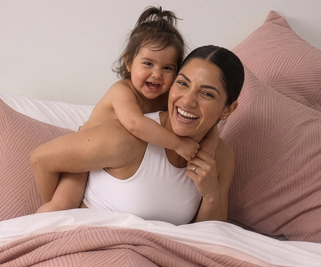 A happy woman with her child after learning about how better sleep improves longevity.