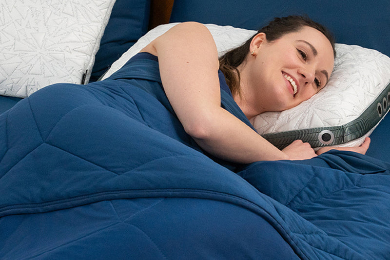 A woman sleeping on a BEDGEAR pillow after learning about memory foam vs. performance pillows.