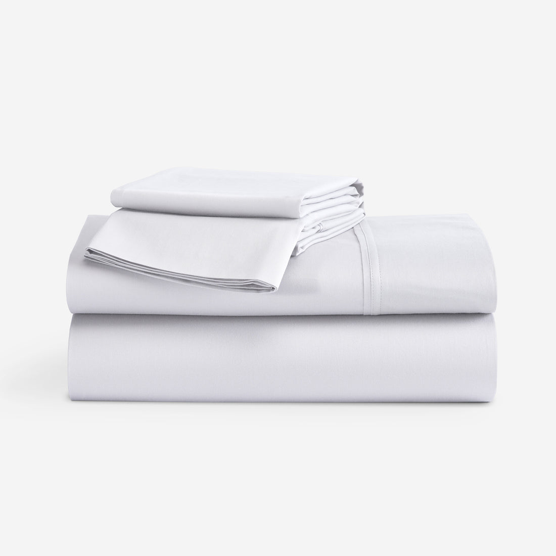 A stack of folded white bedding sheets, including a sheet and a folded pillowcase, on a clean white background. "Bright White"