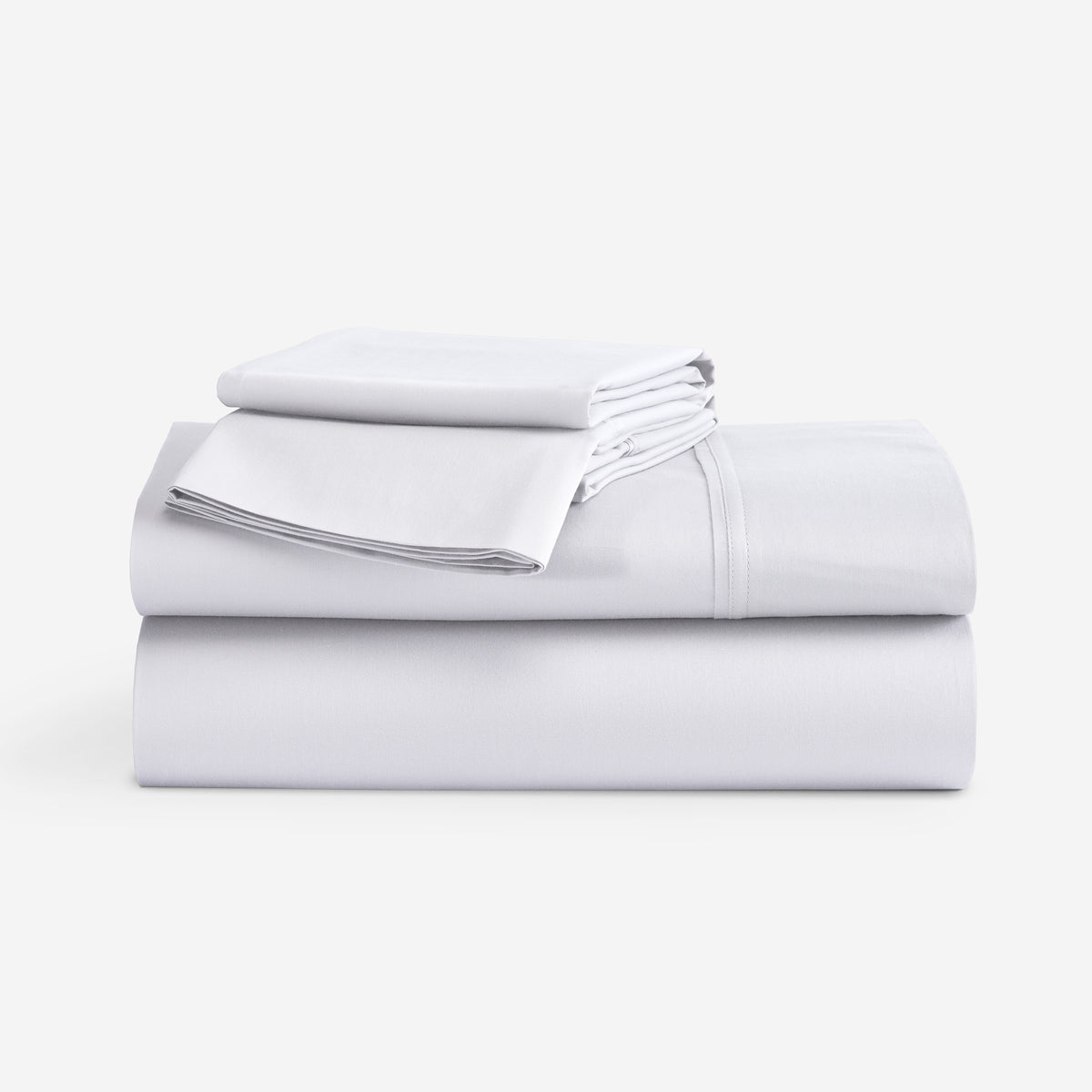 A stack of folded white bedding sheets, including a sheet and a folded pillowcase, on a clean white background.