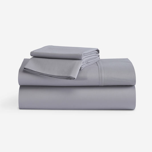 A stack of folded gray bedding, including a folded sheet and folded pillowcases, displayed on a clean white background. "Light Grey"