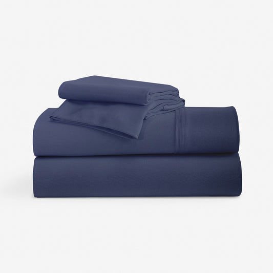 Blue DriTec sheets stacked with a pillowcase. "navy"