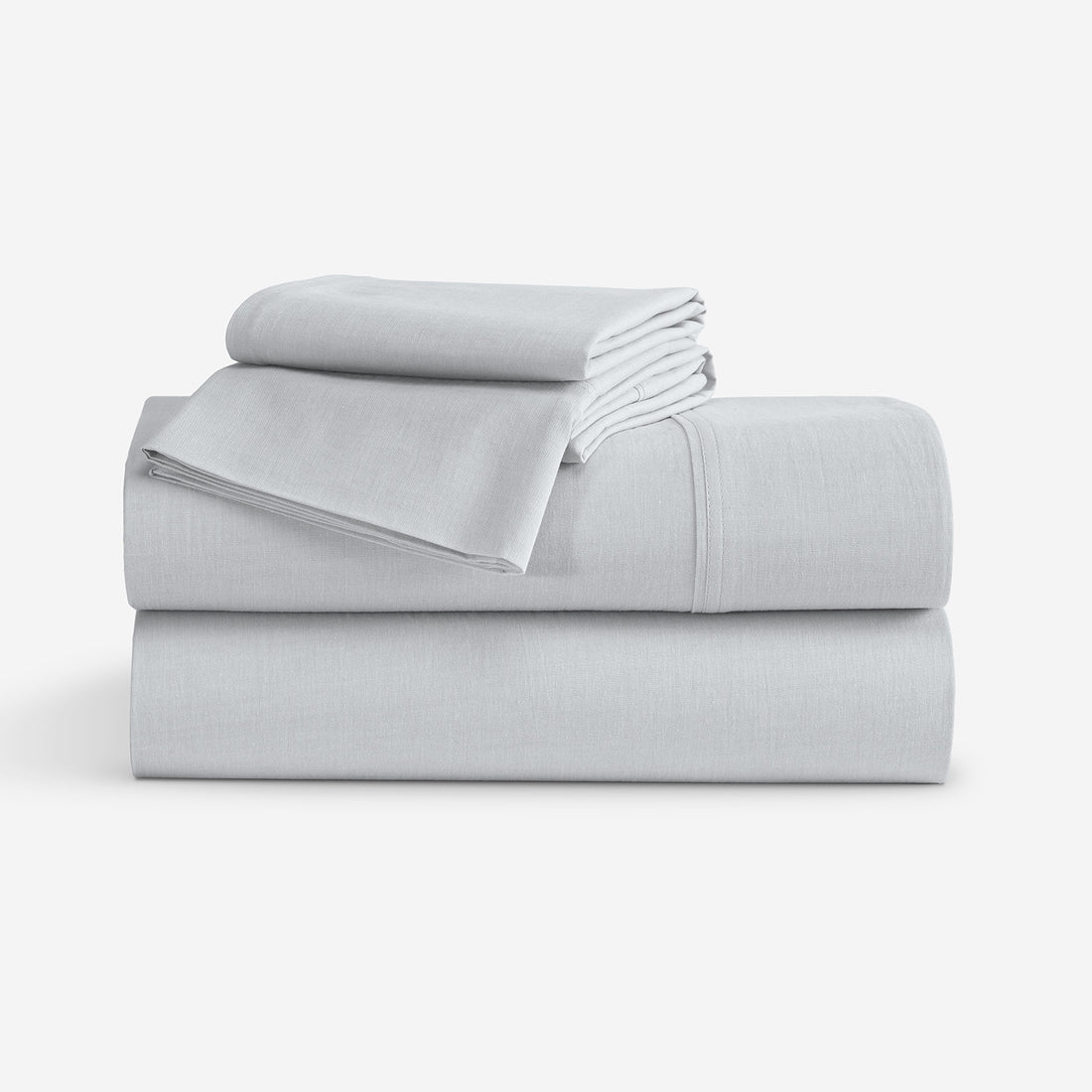 A stack of folded light gray bedding, including a folded sheet and two folded pillowcases, photographed on a clean white studio background. "Light Grey"