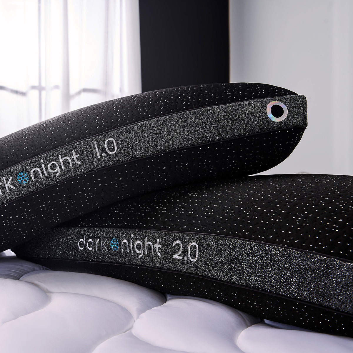 A close up of two dark night king pillows on a bed.