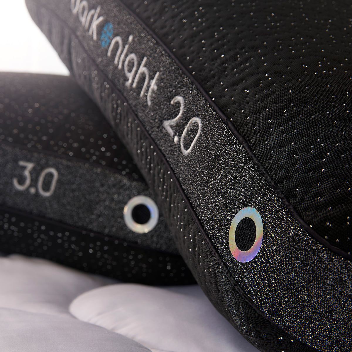 Close-up of two dark night pillows, showing the side air vents.
