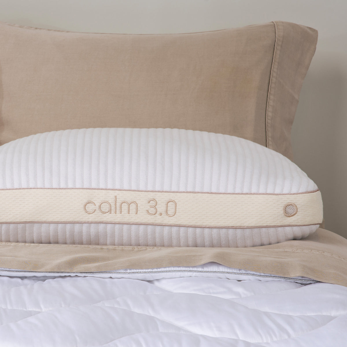 A close up photo of a calm performance pillow on a bed.