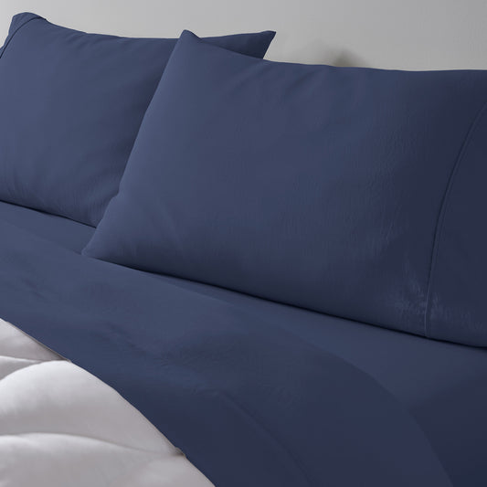 Two pillowcases and essential sheets on a made. 