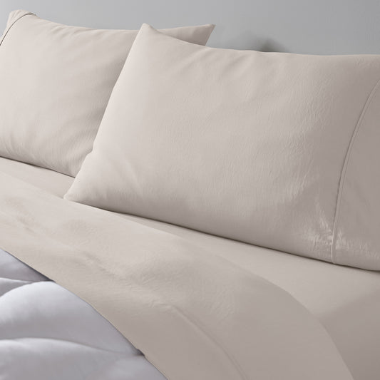 Essential sheets and pillows on a mattress. 