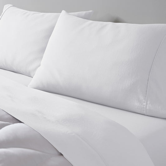 An essential sheet set on a bed in white. 