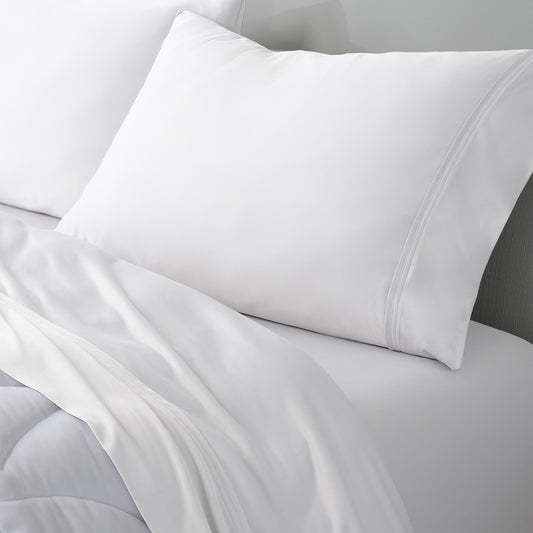 An image of a VerTex pillowcase and sheet set on a bed. 