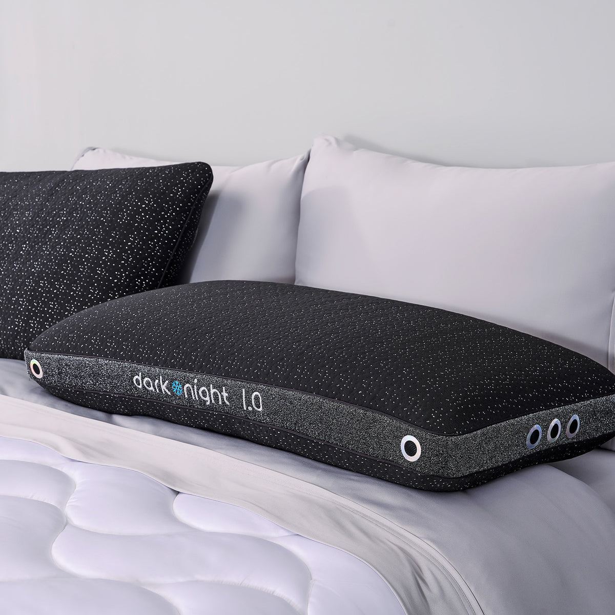 Two dark night 1.0 king pillows on a bed.
