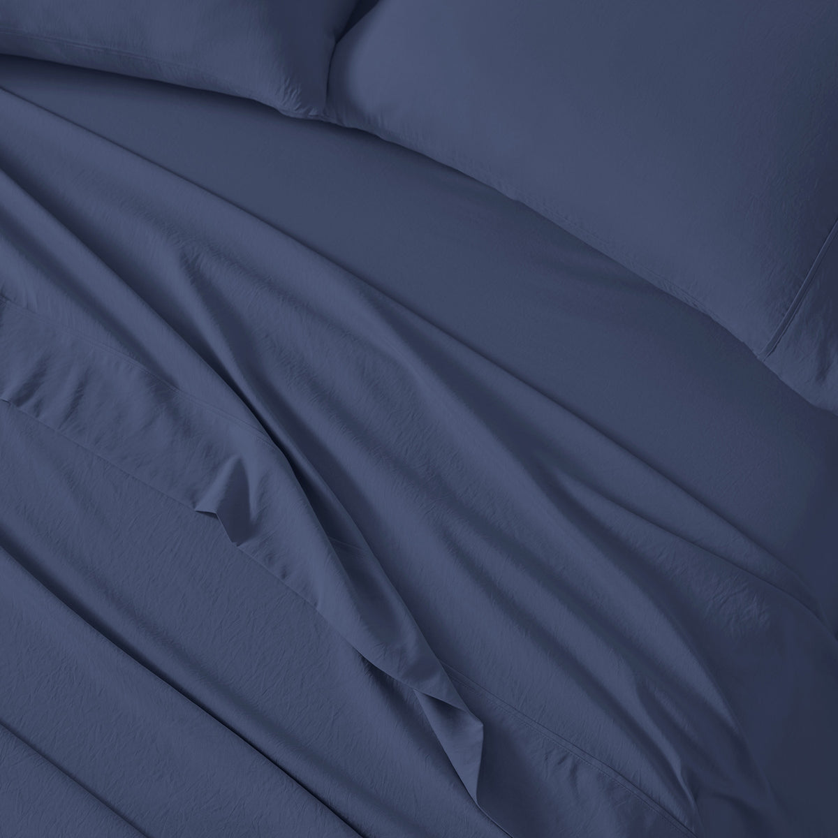 An image of essential sheets on a made bed.