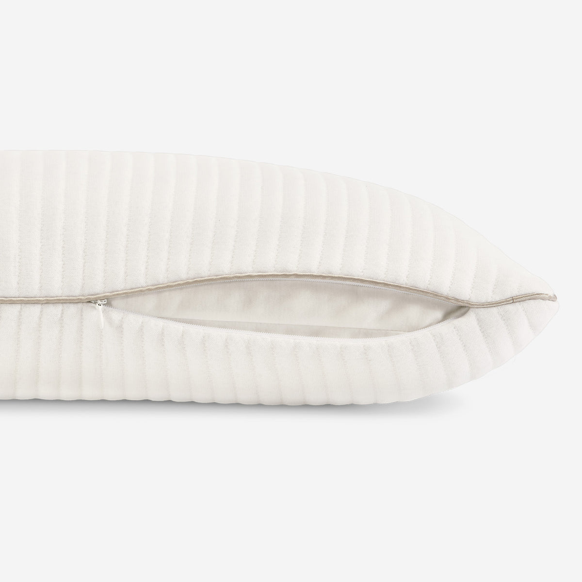 A close-up of the 0.0 Calm Performance Pillow showing its zipper off cover, shown against a plain white background.