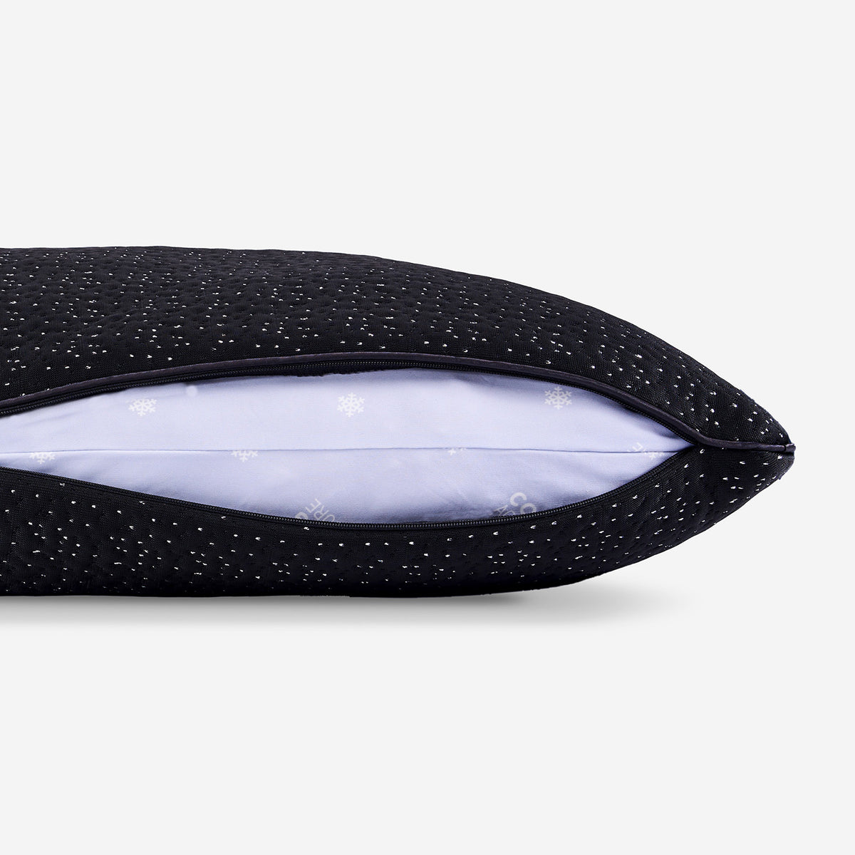 A close-up of a dark night pillow showing its zipper pillow cover.