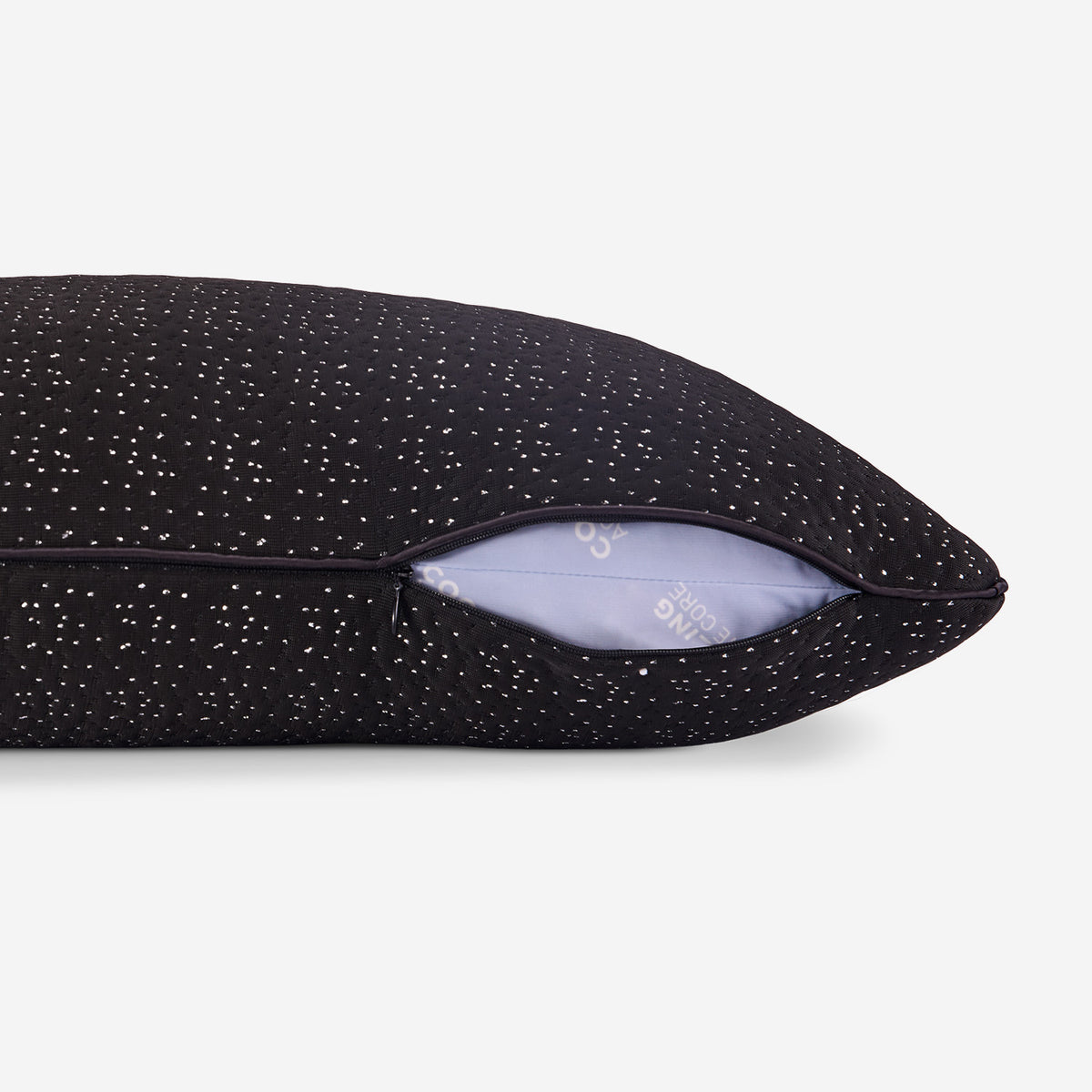 A close-up of a dark night pillow showing a zipper of cover opening.