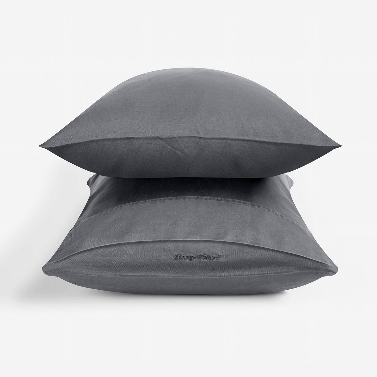 Two dark gray pillowcases on pillows stacked with  a white background.