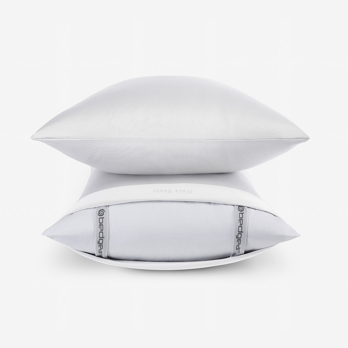 Two white pillowcases stacked in front of a white background.