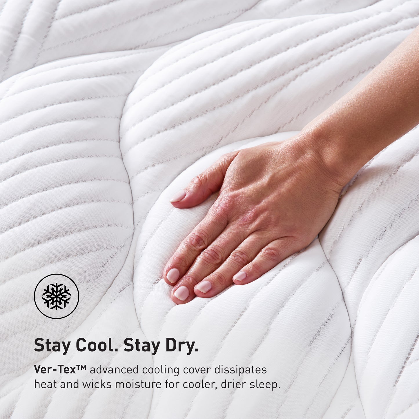 A hand running across BEDGEAR's split head mattress. 