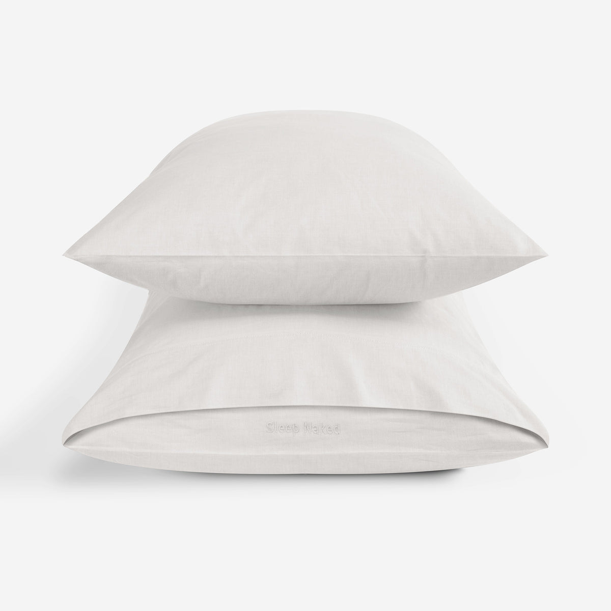 Two ivory pillowcases stacked on a clean white background.