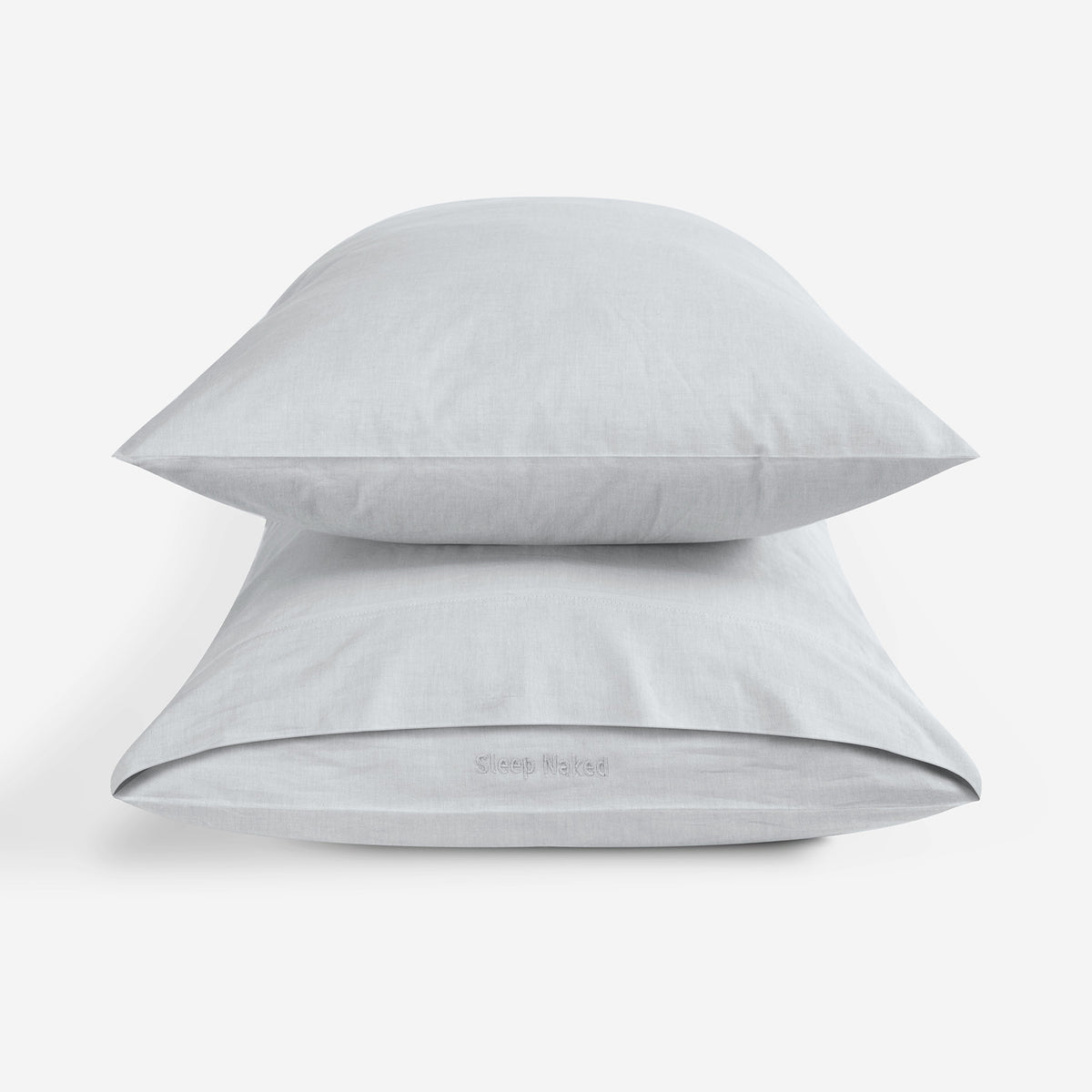 Two light grey pillowcases stacked on a clean white background.