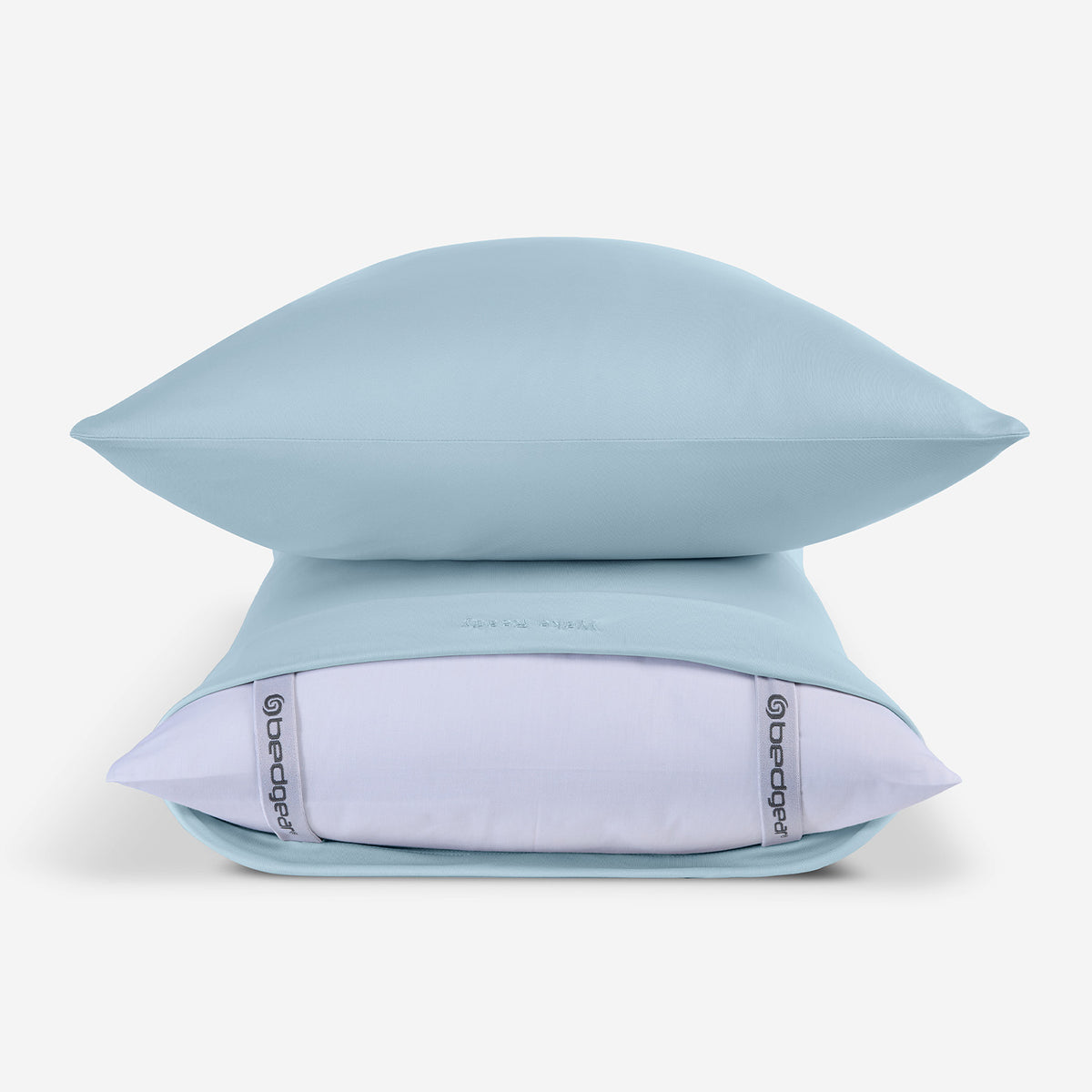Two light blue pillowcases in front of a white background.