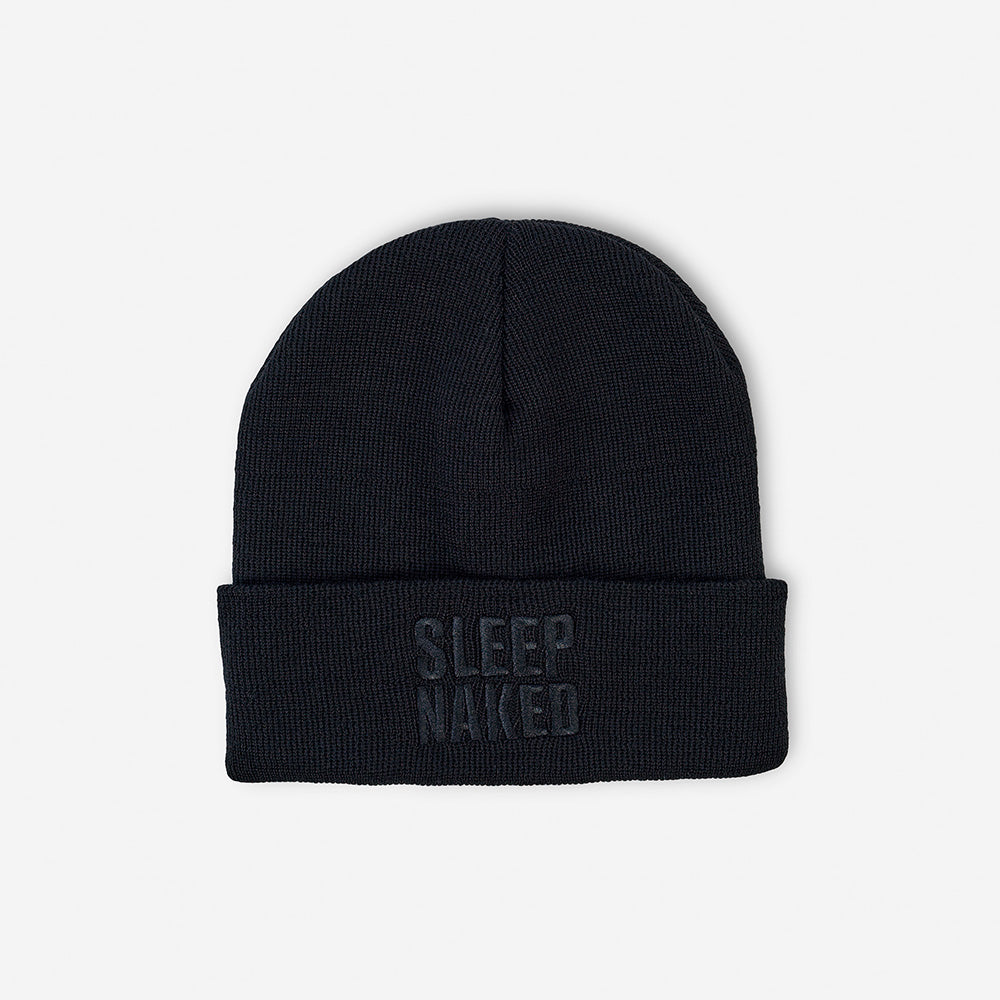 A Sleep Naked beanie in front of a white background. 