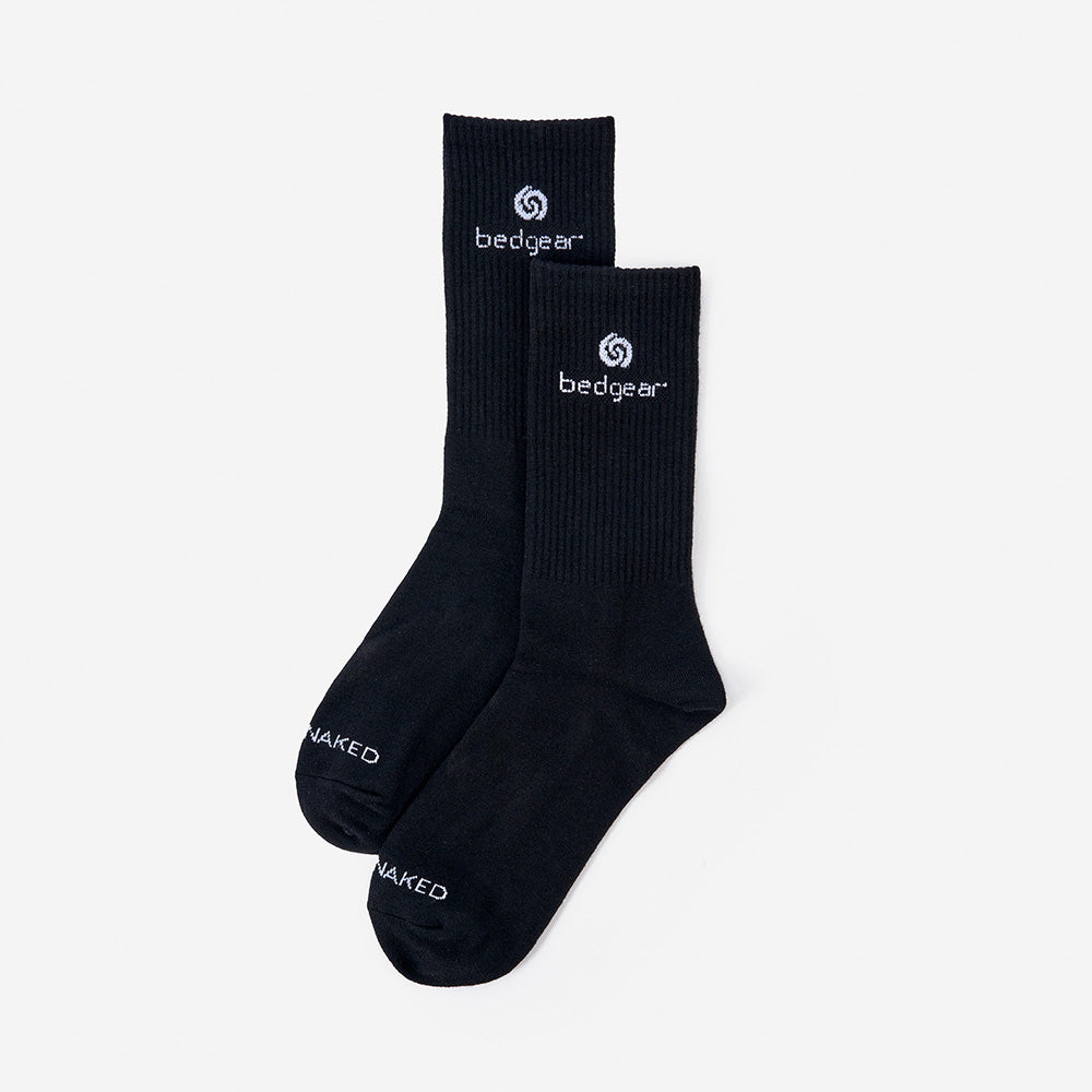 A pair of Sleep Naked crew socks in front of a white background. 