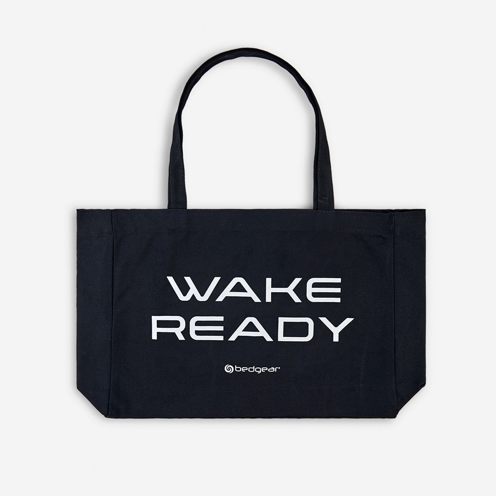 A Wake Ready tote bag in front of a white background. 