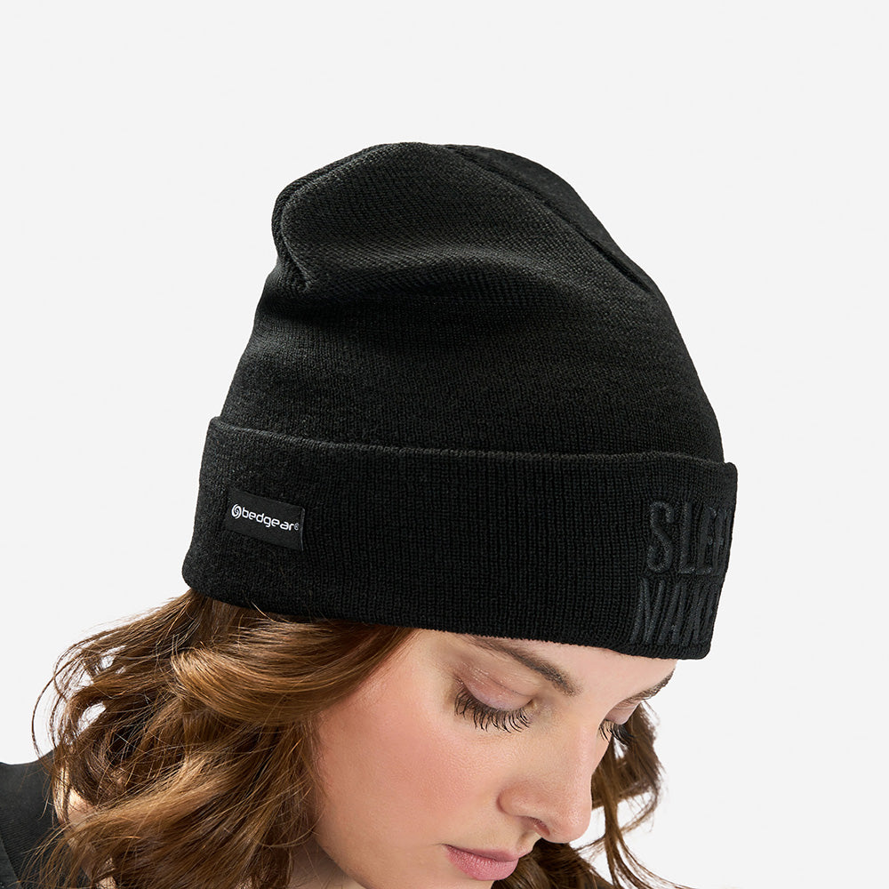 A woman wearing a Sleep Naked beanie. 