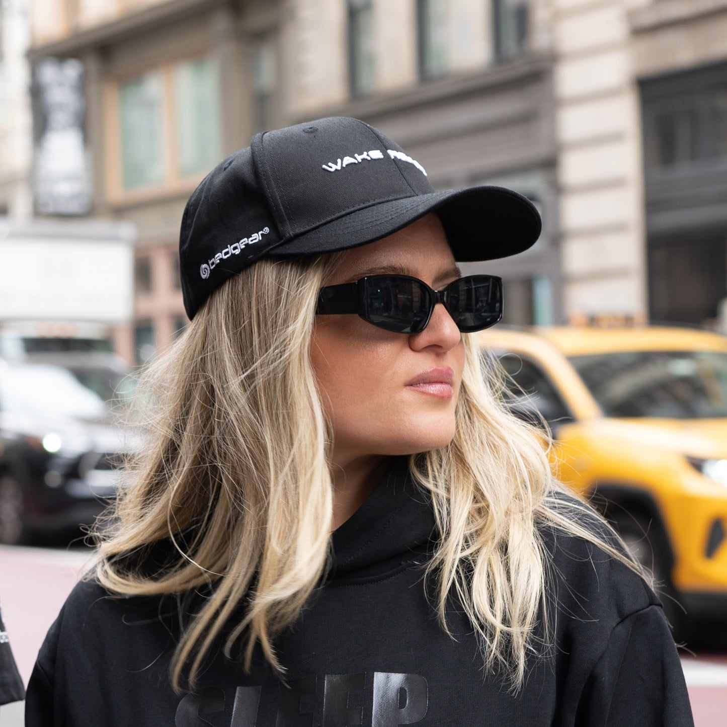 A woman wearing a Wake Ready trucker hat.