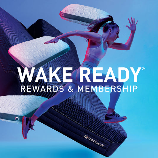 An athletic woman running with Bedgear pillows and a mattress in the background.