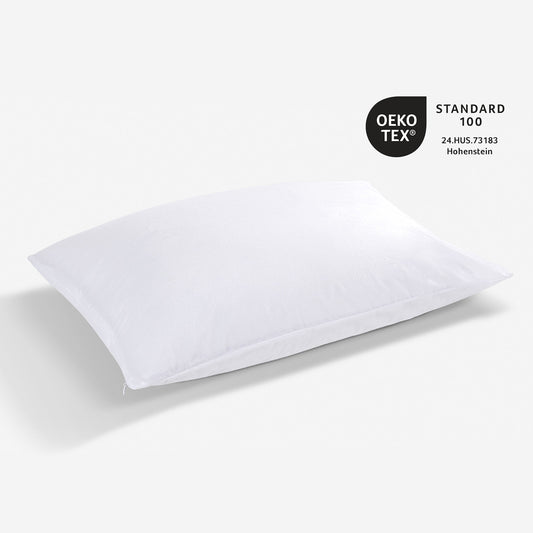 A pillow with an OEKO Tex logo next to it. 